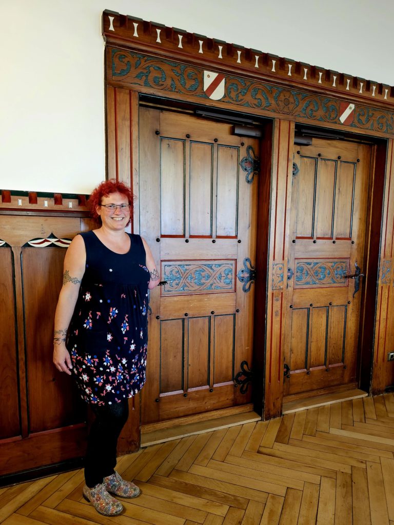 Hotel manager Andrea Weisrock shows the valuable paneling in the conference room at the Hotel Altes Amtsgericht