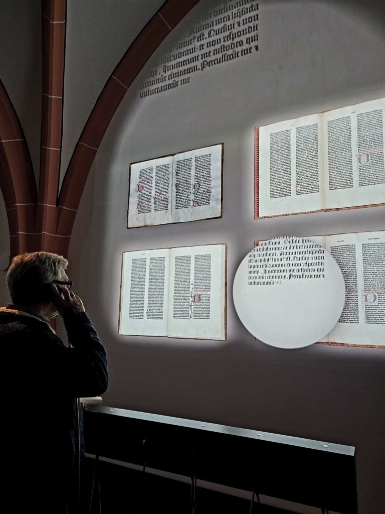 A wall projection shows additional details from the Gutenberg Bibles and brings the pages to life.